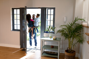 Happy african american children welcoming their father coming back home