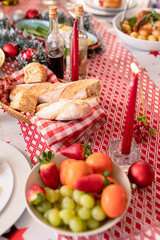 Diverse dishes, candles and christmas decorations lying on table
