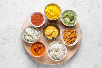 Board with traditional Indian food and spices on grunge background