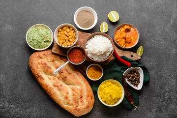Traditional Indian food with spices on dark background
