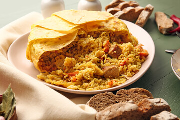 Plate with tasty Shah Pilaf on color wooden background