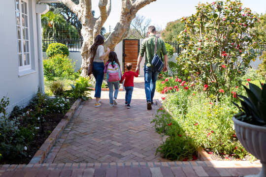 Back View Of Caucasian Family Heading To School And Work