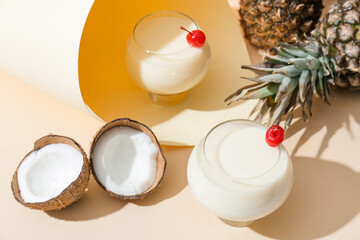 Glasses with tasty Pina Colada cocktail on light background