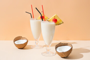 Glasses with tasty Pina Colada cocktail on color background - obrazy, fototapety, plakaty