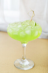 Glass with tasty daiquiri cocktail on color background, closeup