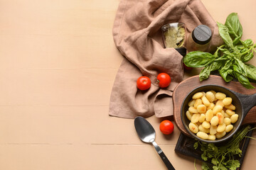 Composition with tasty gnocchi on color wooden background