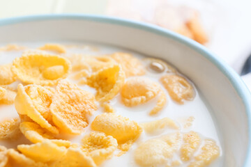 Bowl of tasty cornflakes with milk, closeup