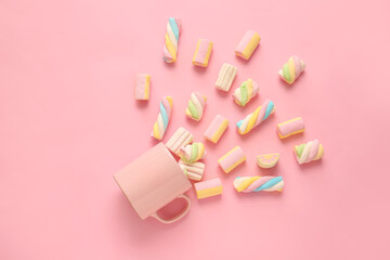 Composition with cup and tasty marshmallows on color background