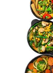 Frying pans with different vegetables on white background