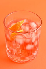 Glass of tasty Negroni cocktail on color background