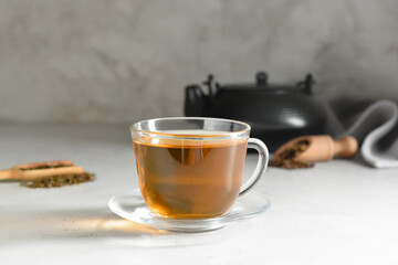 Cup of tasty hojicha green tea on table