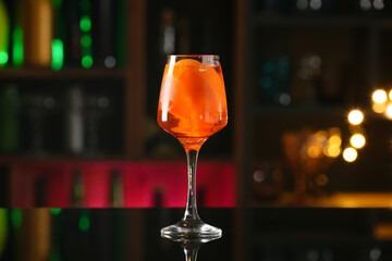 Glass of tasty aperol spritz cocktail on table