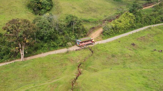 Colombian typical chiva bus in rural roads Drone - 4k. Plantain and coffee sown, 