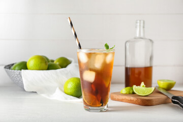 Glass of tasty Long Island iced tea on light background