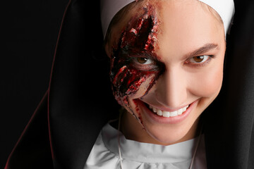 Woman dressed for Halloween as nun on dark background, closeup
