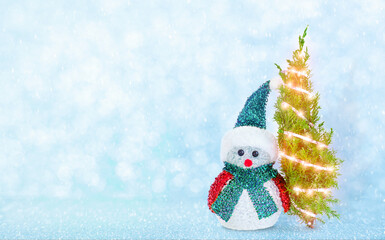 Background with snowman and christmas tree in lights 
