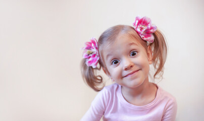 A girl with flowers in her hair is making faces at the camera