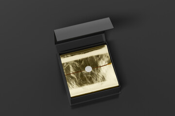 Black opened square folding gift box mock up with gold wrapping paper on black background. View above.