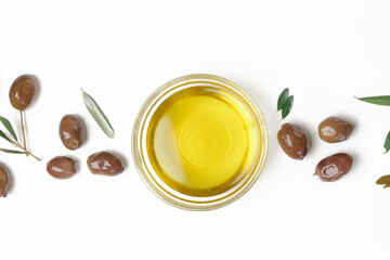Top view of extra virgin olive oil in bowl and olives isolated on white background.	