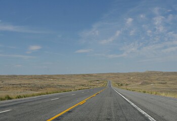 Straight paved road along Wyoming landscape