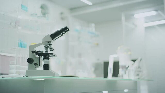 Empty laboratory interior with microscopes and computer