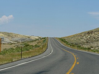 Winding, paved upward road, Wyoming-Montana border landscape