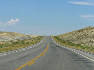 Naklejka premium Paved upward road, Wyoming-Montana border landscape