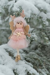 Winter angel on a snowy tree. Snow fairy.Christmas and New Years time. Christmas tree toy. High quality photo
