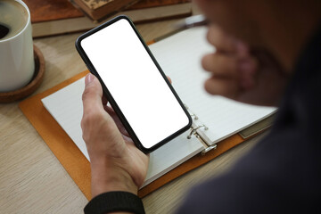 Close up view businessman holding smart phone with blank screen.