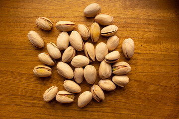 top view of many pistachios on a wooden background