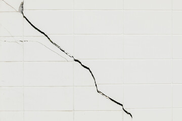 The walls of buildings are cracked and damaged by substandard construction, soil subsidence, and earthquakes.