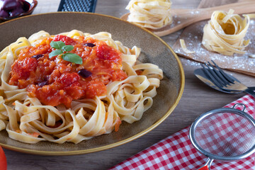 Traditional pasta tagliatelle spaghetti on the table.