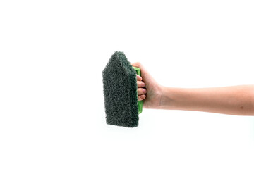 Close up human hand holding a green plastic scrubber isolated on white background.