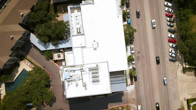 Aerial birds eye view traffic through urban developing area in big city, drone 4K