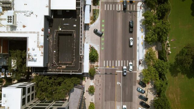 Bird's eye aerial view traffic on busy urban street downtown Austin Texas, drone 4K