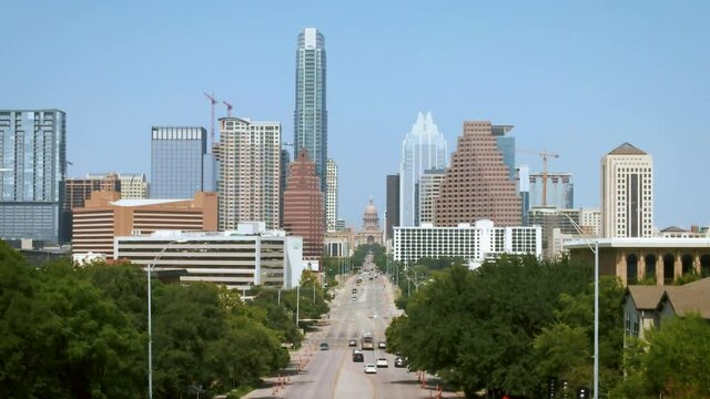 Aerial of tree lined South Congress Avenue leading to Texas Capitol building in Austin, drone 4K