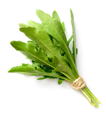 bunch of fresh rocket leaves isolated on white background, top view