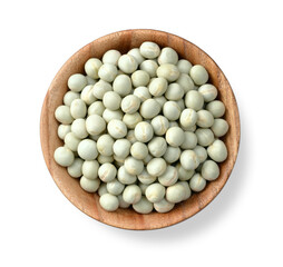 uncooked dried green peas in the wooden bowl, isolated on the white background, top view