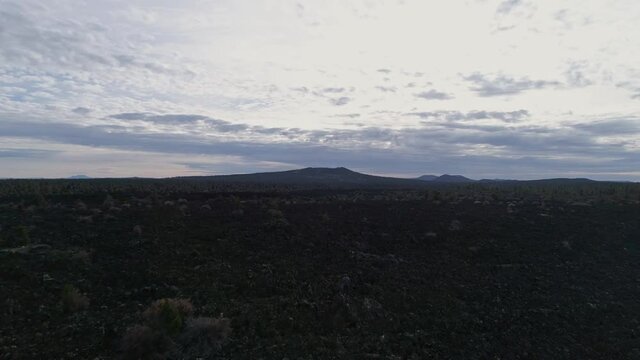 Aerial passing over Zuni-Bandera Volcanic Lava field outside El Malpais, 4K