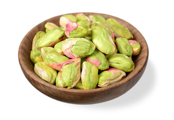 peeled pistachios in the wooden plate, isolated on the white background
