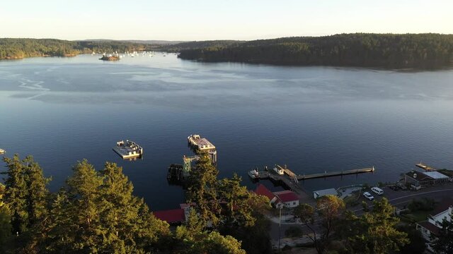 Cinematic 4K aerial drone pan shot of Orcas Village, sailboats and yachts anchored at Blind Bay and Hudson Bay on Shaw Island off the Harney Channel in the San Juan Islands in Washington