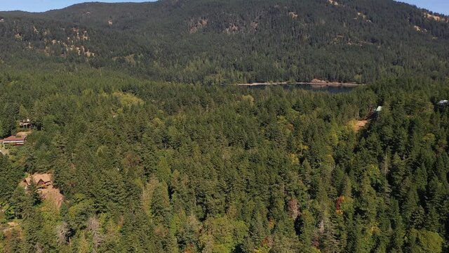 Cinematic 4K aerial drone rise and reveal footage of Cascade Lake and Moran State Park on Orcas Island in Washington