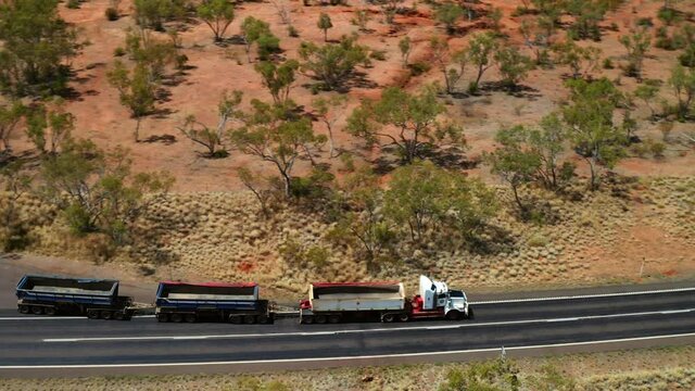 Three-trailer Road Train With Empty Freight Driving In Outback Road In QLD, Australia. - aerial