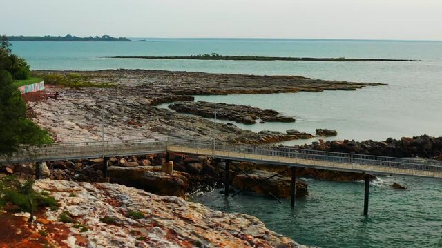 Jetty At The Nightcliff Pier In Darwin, Northern Territory Of Australia With Rocky Coast. aerial drone