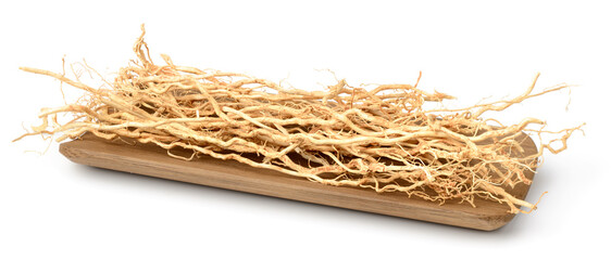 dried vetiver roots in the wooden plate, isolated on the white background