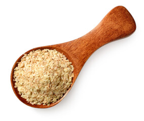 uncooked wheat germ in the wooden spoon, isolated on the white background, top view