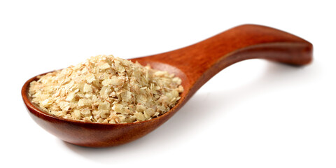 uncooked wheat germ in the wooden spoon, isolated on the white background