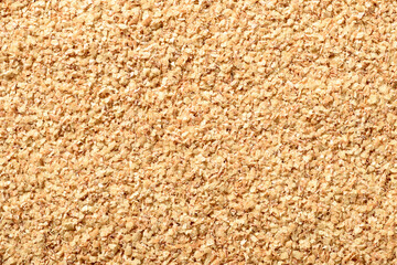 food background of uncooked wheat germ, top view