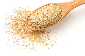 uncooked wheat germ in the wooden spoon, isolated on the white background, top view