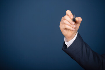 Businessman holding a pen and writing gesture. Copy space
